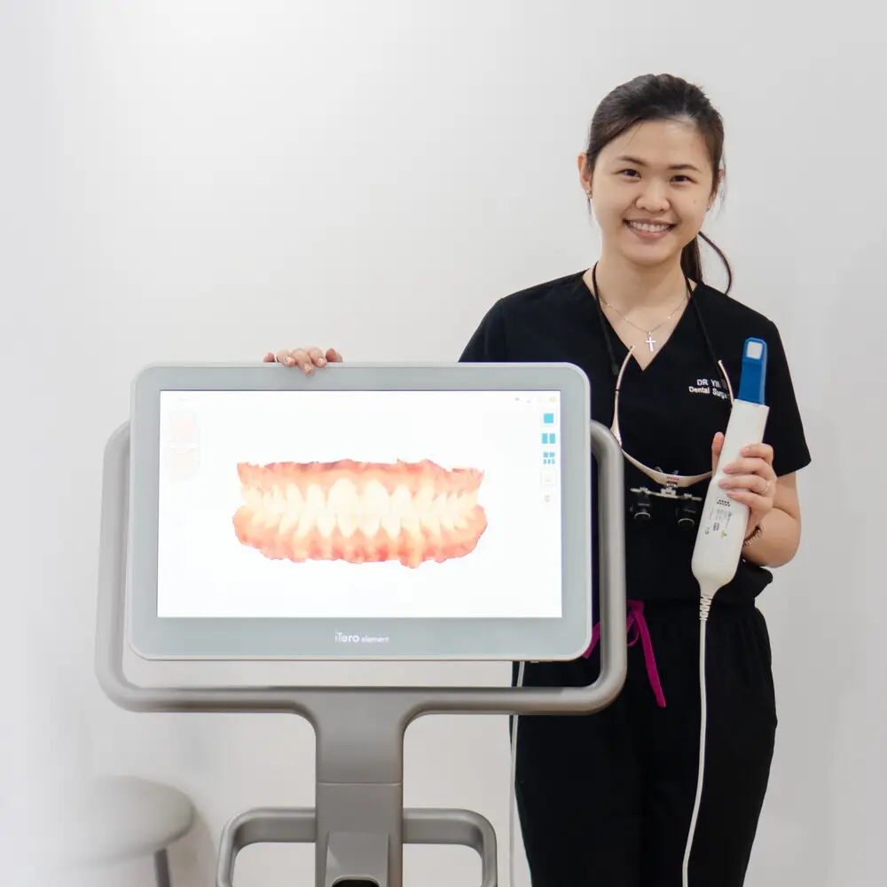 Doctor Ying Ying, a Platinum Elite Invisalign Provider in Kuching, presenting the iTero 3D Scanner machine that analyses a patient's teeth.